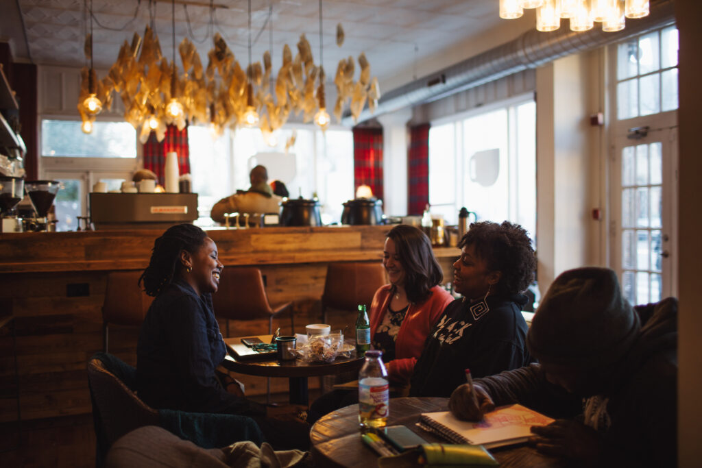 Patrons laughing at Uncle Bobbie's, a bookstore café in Philadelphia. 